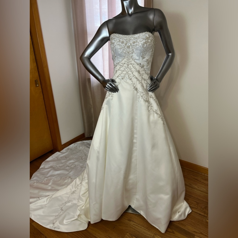 Ivory satin strapless A-line wedding gown with beaded bodice.